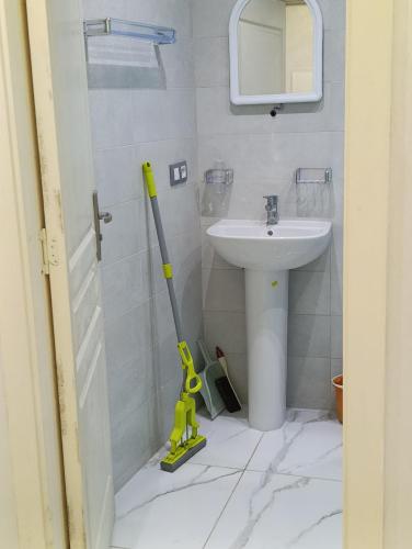 ein Badezimmer mit einem Waschbecken und einem Mopp in der Unterkunft Martil, Tetuán Apartamento in Martil