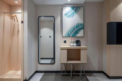 a bathroom with a mirror and a sink and a counter at UP and IN Hotel Anhui Ma'anshan Wanda Plaza in Ma'anshan