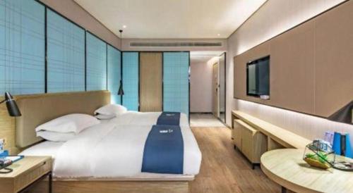 Ένα ή περισσότερα κρεβάτια σε δωμάτιο στο Echarm Hotel Guilin Railway Station the MixC