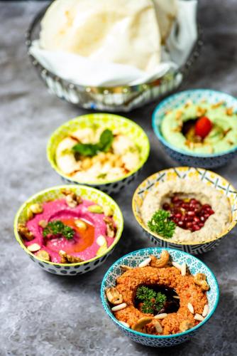 a group of bowls filled with different types of food at Movenpick Hotel Centaurus Islamabad in Islamabad