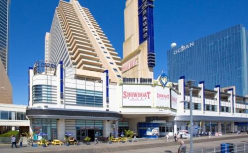 a large building with people walking in front of it at CozySuites Modern Studio Condo at Showboat #29 in Atlantic City