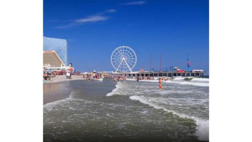 a beach with a ferris wheel in the background at CozySuites Modern Studio Condo at Showboat #29 in Atlantic City