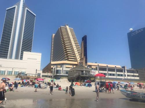 a group of people on a beach with buildings at CozySuites Modern Studio Condo at Showboat #30 in Atlantic City