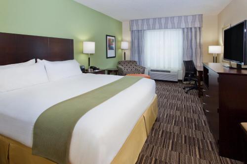 a hotel room with a large bed and a desk at Holiday Inn Express Hotel & Suites Huntsville West - Research Park by IHG in Huntsville