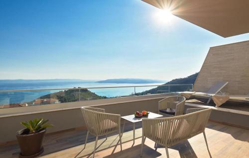 a balcony with a table and chairs with a view at Awesome Home In Makarska With Sauna in Makarska
