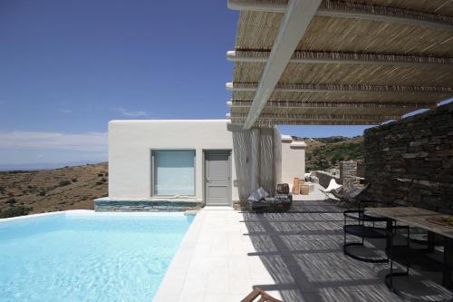 a villa with a swimming pool and a house at Villa Orso Blue II in Ioulida