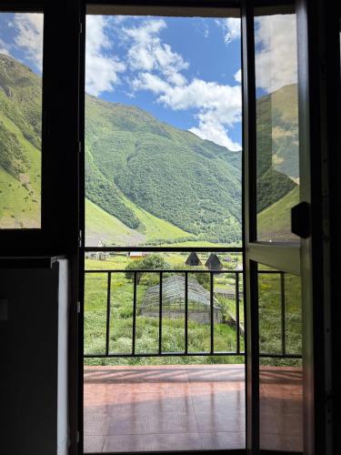 a view from a door looking out at the mountains at OISHE Boutique Hotel in Stepantsminda