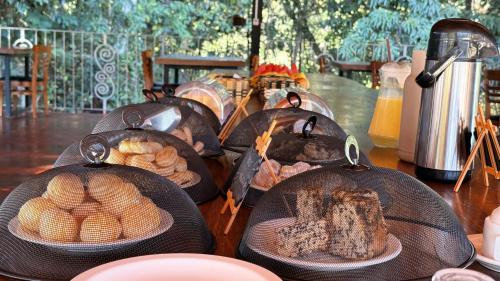 een groep kommen met eten op een tafel bij Pousada de Campo Estância Bahamas in Pirenópolis