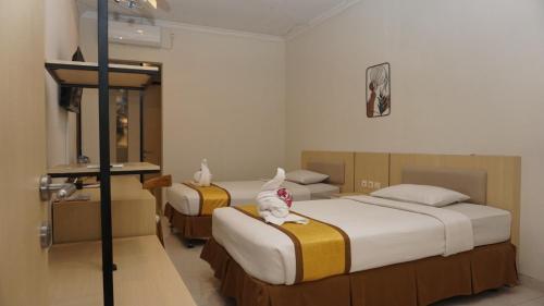 Postel nebo postele na pokoji v ubytování LPP Garden Hotel
