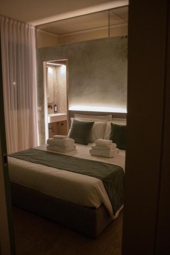 a bedroom with a large bed with towels on it at Villa Margherita in Padova