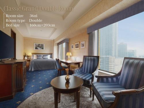 a hotel room with a bed and a large window at Nagoya Kanko Hotel in Nagoya