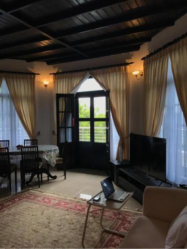a living room with a couch and a tv at Holiday Villa in Nikawatawana