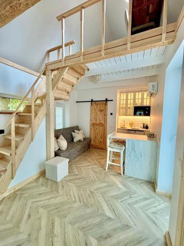 a loft apartment with a loft bed and a kitchen at Charming Cottage - Sauna - Central Location in Šiauliai