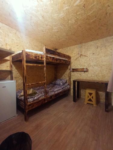 a room with two bunk beds and a wooden floor at Camping Three poplars by VL in Alaverdi