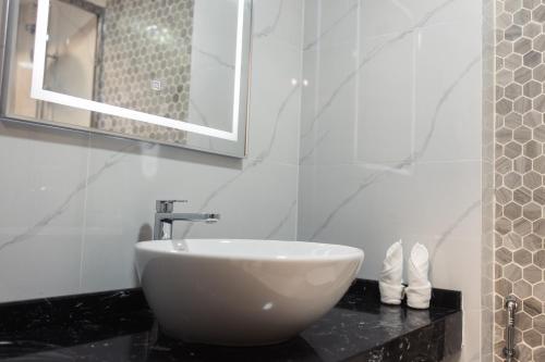 a white sink on a black counter in a bathroom at Comfy Quite Private Room- Hulhumale in Hulhumale