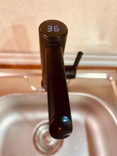 a black faucet on top of a sink at LEB Apartments in Pineda de Mar