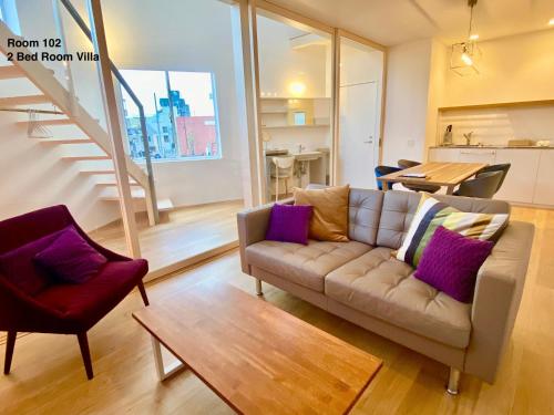 a living room with a couch and a table at Villa Monica EAST in Nagoya
