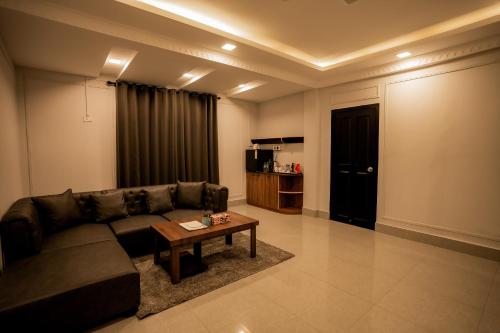a living room with a couch and a coffee table at Hotel D'Palazzo in Kohīma