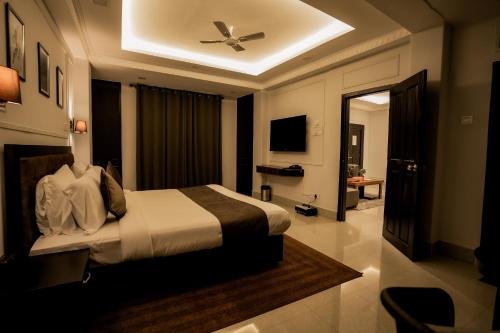 a bedroom with a bed with a ceiling fan at Hotel D'Palazzo in Kohīma