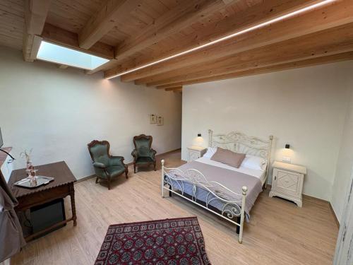 a bedroom with a bed and a table and chairs at Cascina Monte Tivino in Salò