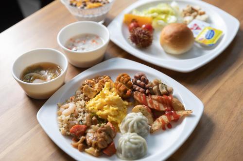 three plates of breakfast food on a table at With Stay Jeju Hotel in Jeju