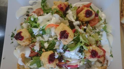 a plate of food with a salad on a table at Hotel Restaurant Jägerhof in Braunschweig