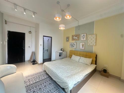 a bedroom with a bed and a couch at Luxe Paradise 21 Nguyen Van Troi in Hanoi