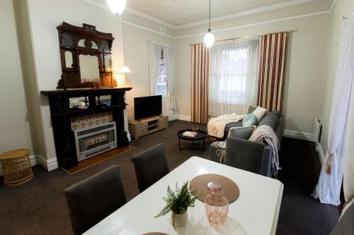 a living room with a couch and a table at Bendigo Signature Accommodation on Barnard in Bendigo