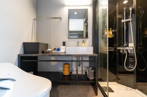 a bathroom with a sink and a shower at HOTEL TABARD TOKYO in Tokyo