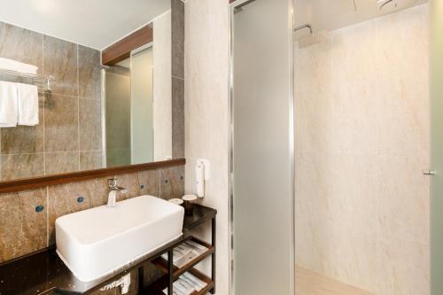 a bathroom with a sink and a shower at With Stay Jeju Hotel in Jeju