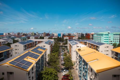 an overhead view of buildings with solar panels on their roofs at Comfy Quite Private Room with Private Balcony - Hulhumale in Hulhumale