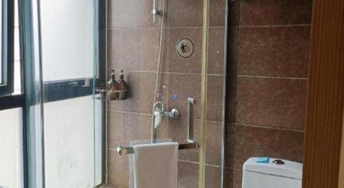a bathroom with a shower with a toilet and a sink at IU Hotel Chengdu High-Tech Zone Longhu Times Street in Chengdu