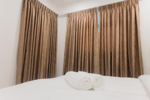 a bedroom with a bed with two towels on it at Comfy Quite Private Room with Private Balcony - Hulhumale in Hulhumale