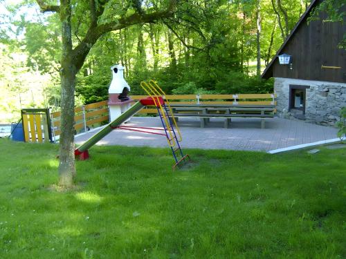 a playground with a slide in the grass at Heizmannshof in Hofstetten
