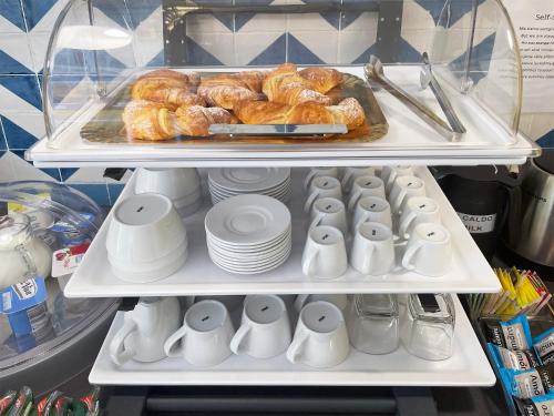 a refrigerator filled with lots of pastries and croissants at I Registi in Scalea