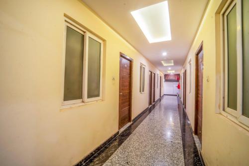 an empty corridor in a building with windows and a ceiling at HOTEL AUGUSTO in Varanasi