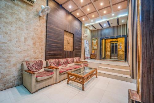 a living room with two couches and a coffee table at HOTEL AUGUSTO in Varanasi
