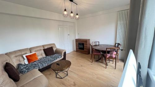 a living room with a couch and a table at Flat in London Bridge in Moffat
