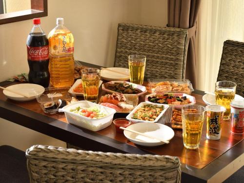 a table topped with dishes of food and drinks at TATAMI NO YADO Naha Tsuboya by Coldio Premium in Naha
