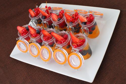 a white plate with a bunch of drinks and carrots at Lolli Palace Hotel in Sanremo