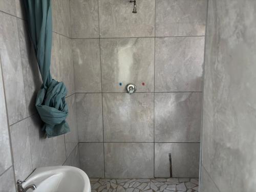 a bathroom with a shower with a toilet in it at Hlalanathi Lodges - 25 North Drive Margate in Margate