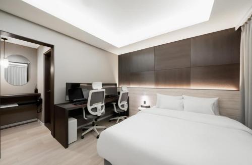 Ένα ή περισσότερα κρεβάτια σε δωμάτιο στο Hotel Lantana Sangmu