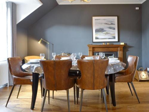 a dining room with a table and chairs at Darroch View in Ballater