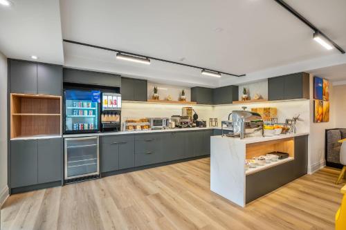 a large kitchen with gray cabinets and a counter at Comfort Inn in Guelph
