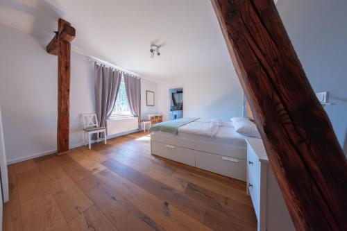 a bedroom with a bed and a wooden floor at Ferienwohnung Hof Armada in Wiesbaden