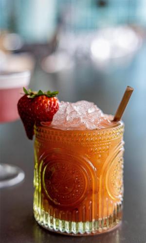 a drink with a strawberry on top of it at Conrad Nashville in Nashville