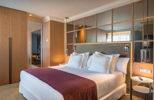 a hotel room with a large bed with white pillows at Barceló Emperatriz in Madrid