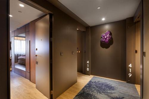 a hallway with a door with a butterfly on the wall at Barceló Emperatriz in Madrid
