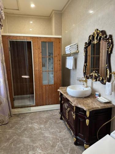 a bathroom with a sink and a shower with a mirror at Dream Boutique Hotel in Da Lat