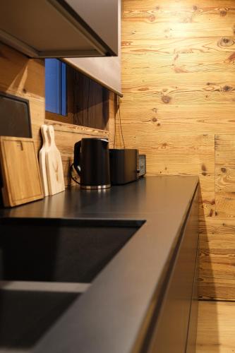 a counter top in a kitchen with wooden walls at Leos Chalet in Valdaora di Sopra